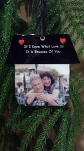 A picture of an old couple hanging on the tree.